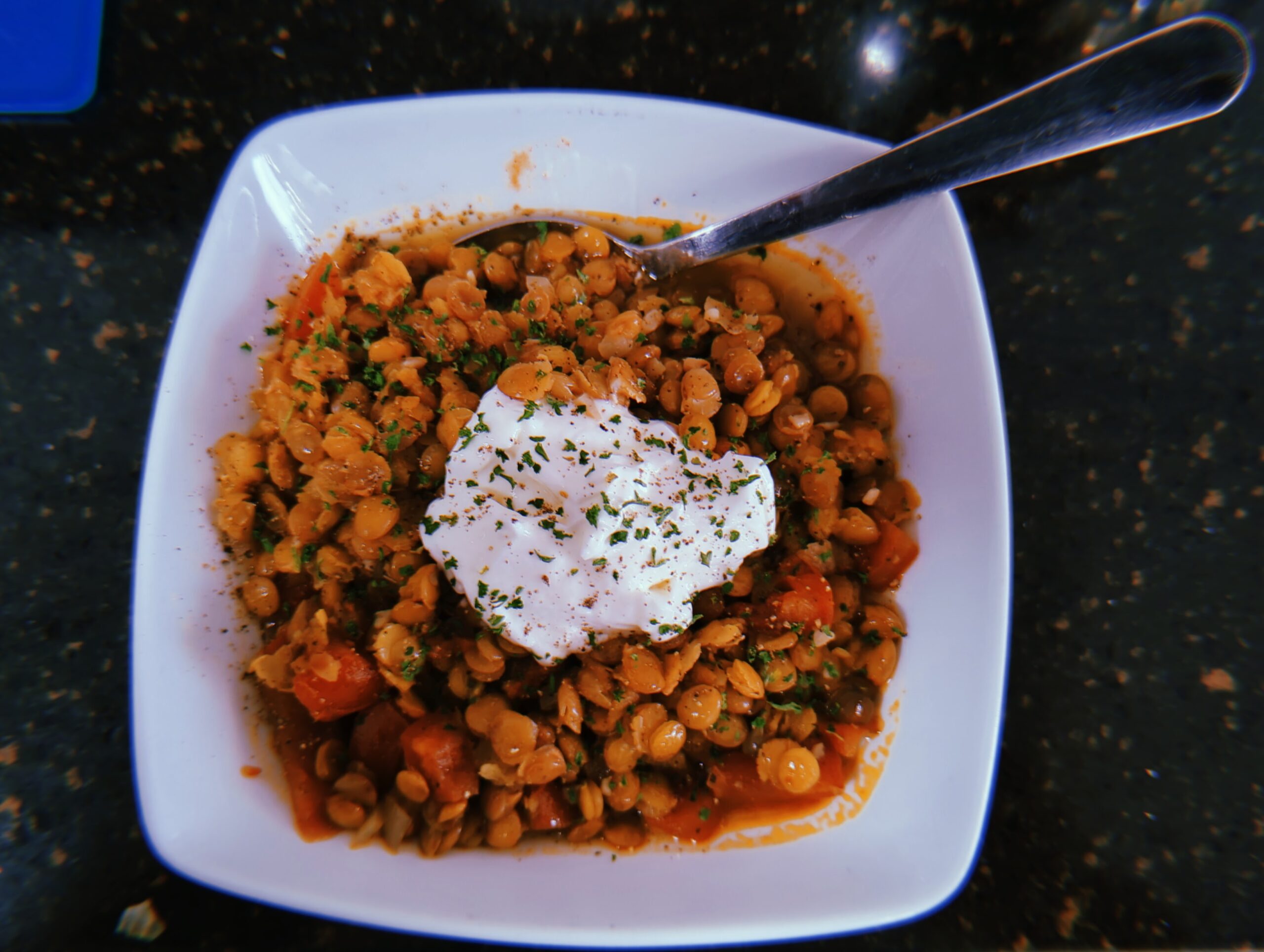 A Bowl of Lentils cooked Morrocan style with cream and parsley on top